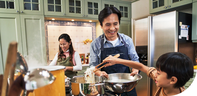 Image of family making dinner together in kitchen